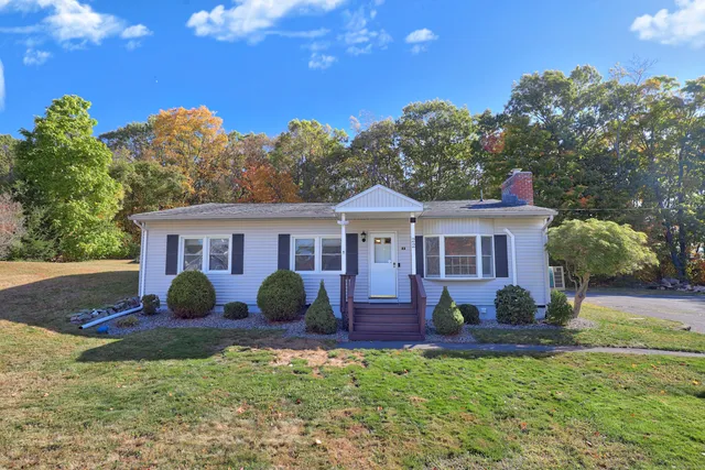 a front view of a house with garden