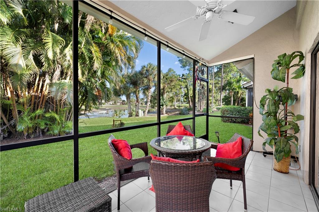 908 Augusta Boulevard, Unit A907 Naples, FL 34113 - Photo 2 of 20 a view of a dining tables and chairs in a yard