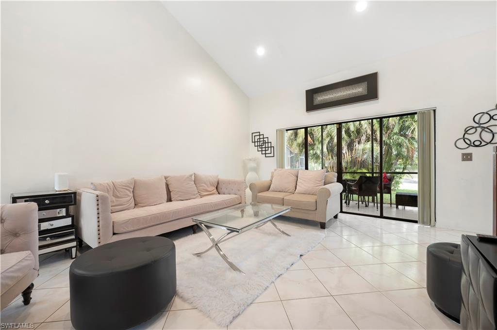 908 Augusta Boulevard, Unit A907 Naples, FL 34113 - Photo 5 of 20 a living room with furniture and large window