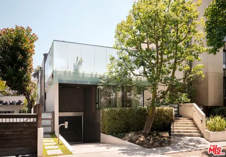 a front view of a house with tree s