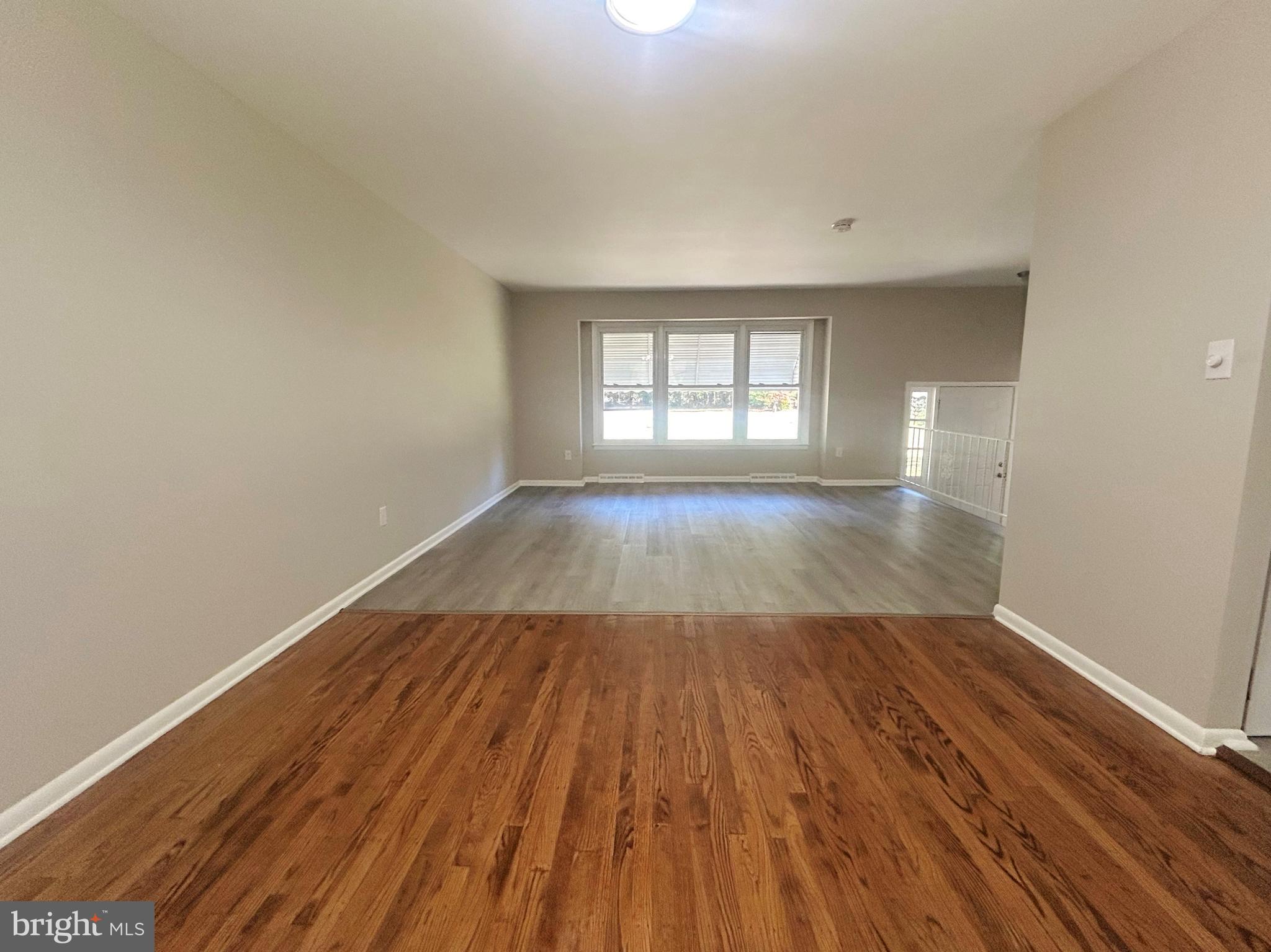 741 North Tuckahoe Road Williamstown, NJ 08094 - Photo 5 of 14 an empty room with wooden floor and windows