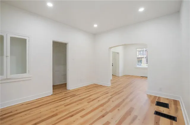 a view of empty room with wooden floor