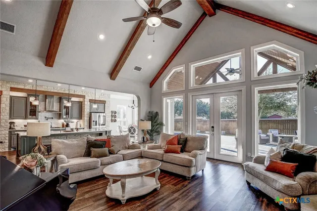 a living room with furniture and wooden floor