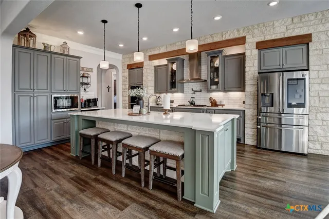 a large white kitchen with a sink and dishwasher