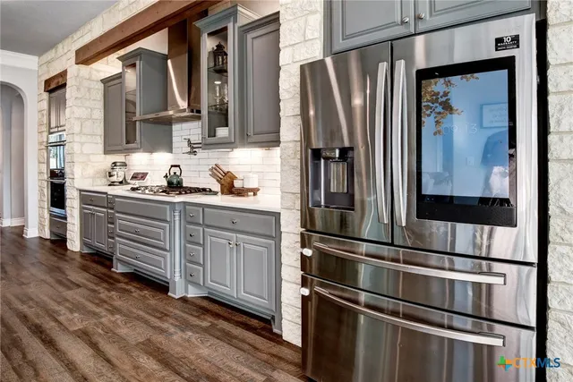 a kitchen with cabinets and wooden floor