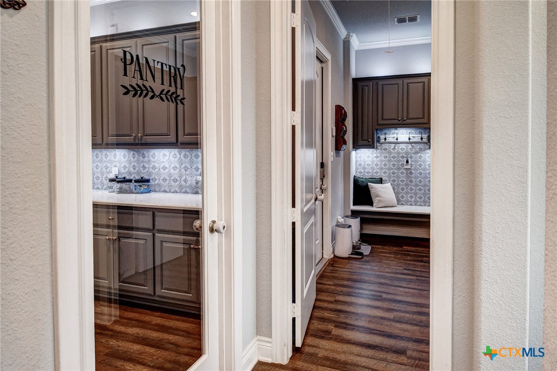 222 August Avenue Shiner, TX 77984 - Photo 19 of 48 a view of a hallway with wooden floor and a bathroom