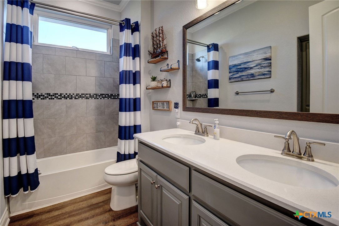 222 August Avenue Shiner, TX 77984 - Photo 30 of 48 a bathroom with a sink a toilet and shower