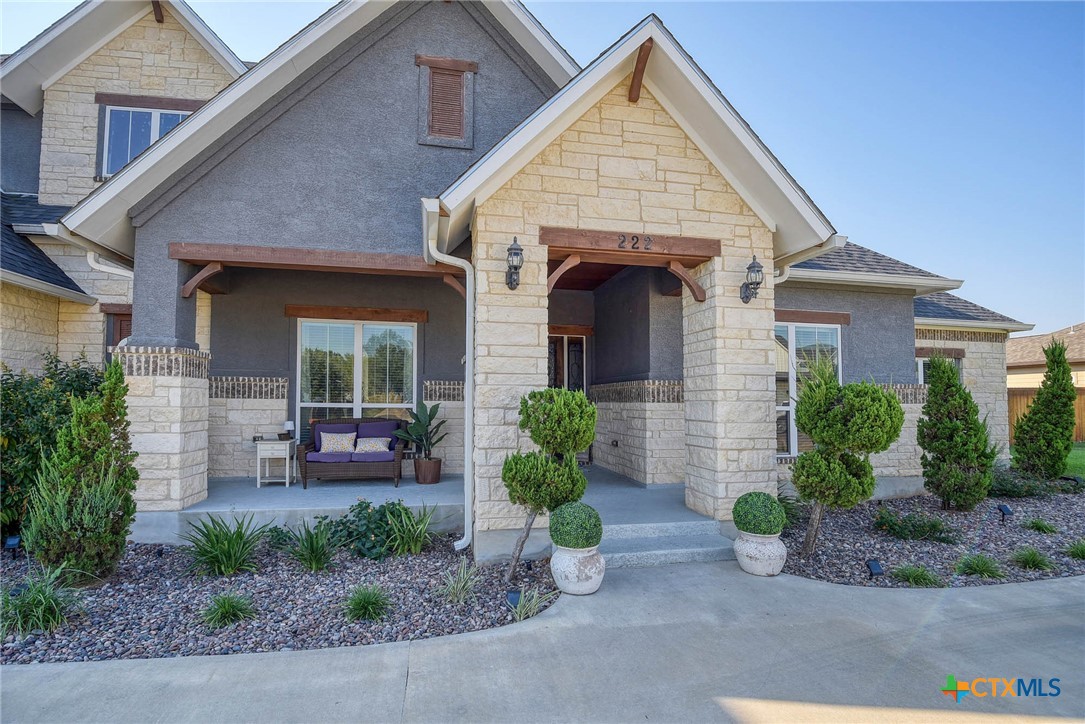 222 August Avenue Shiner, TX 77984 - Photo 3 of 48 a view of a house with a yard and potted plants