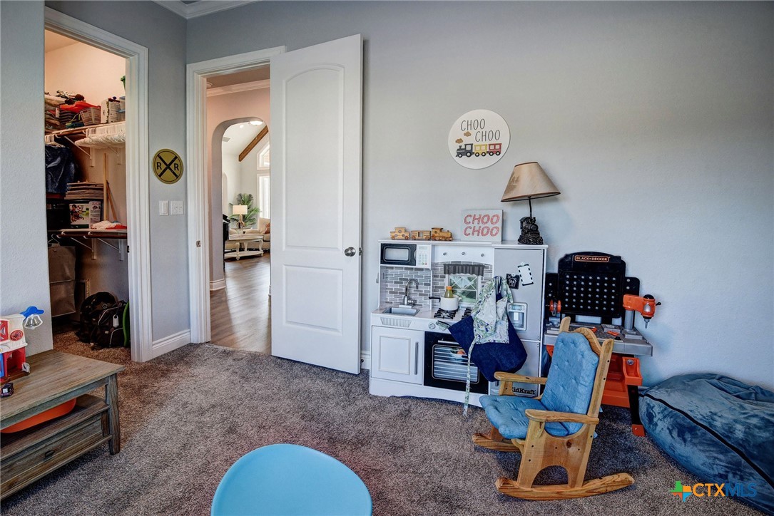 222 August Avenue Shiner, TX 77984 - Photo 32 of 48 a living room with furniture and a lamp