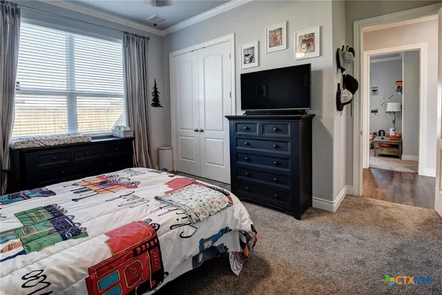 a bedroom with a bed and a dresser