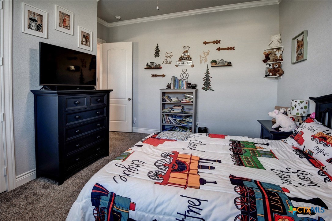 222 August Avenue Shiner, TX 77984 - Photo 36 of 48 a bed room with a bed a television and a couch