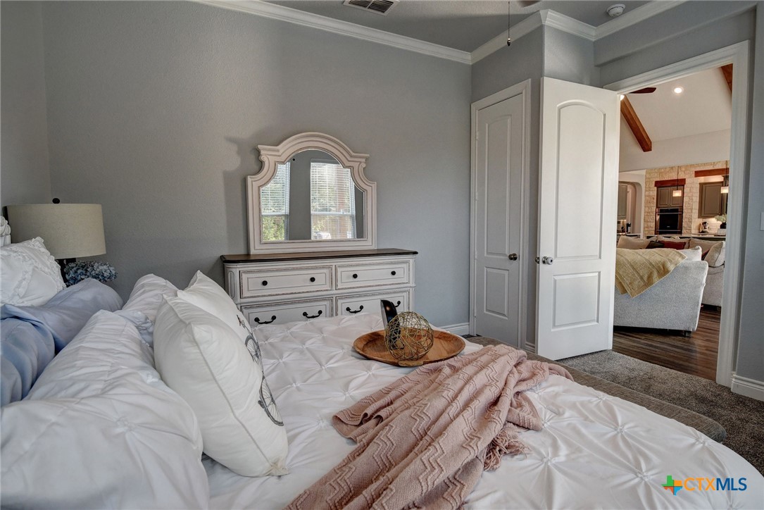 222 August Avenue Shiner, TX 77984 - Photo 38 of 48 a bedroom with a bed and a dresser