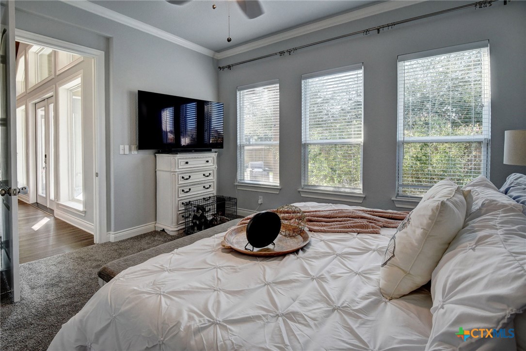 222 August Avenue Shiner, TX 77984 - Photo 39 of 48 a bedroom with a bed and a flat screen tv