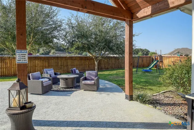 a view of swimming pool with outdoor seating and plants