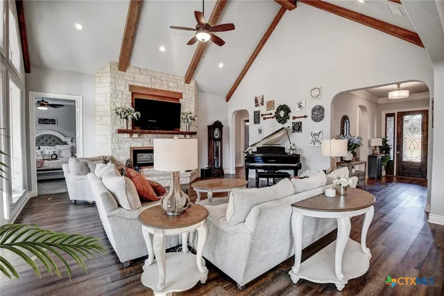 a living room with furniture a flat screen tv and a fireplace