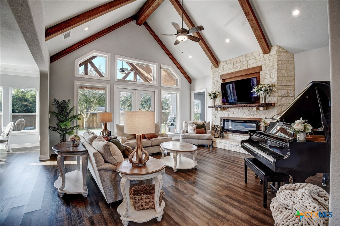 222 August Avenue Shiner, TX 77984 - Photo 10 of 48 a living room with furniture a flat screen tv and a fireplace