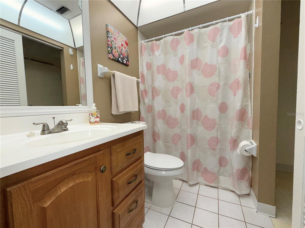 11817 Bayonet Lane New Port Richey, FL 34654 - Photo 11 of 32 a bathroom with a granite countertop sink toilet and a mirror