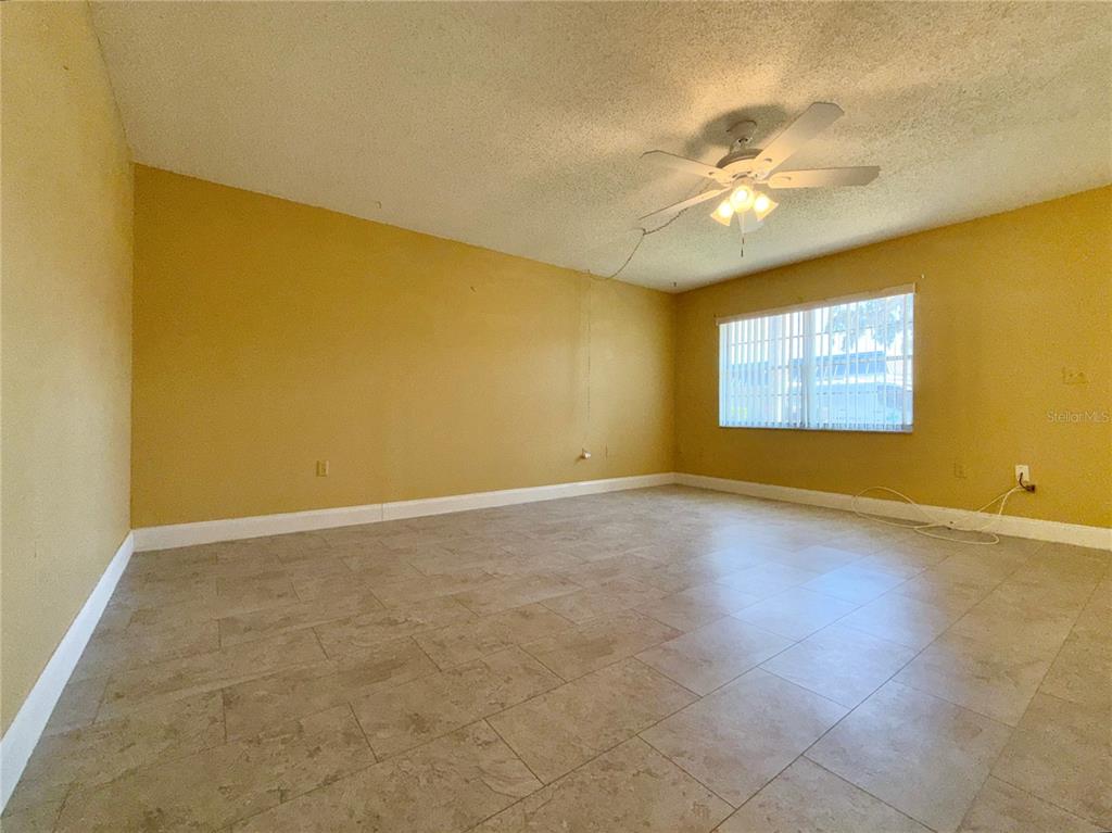 11817 Bayonet Lane New Port Richey, FL 34654 - Photo 3 of 32 a view of an empty room with chandelier fan and fire place