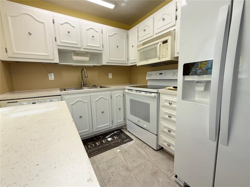 11817 Bayonet Lane New Port Richey, FL 34654 - Photo 6 of 32 a kitchen with stainless steel appliances granite countertop a stove a sink and a refrigerator