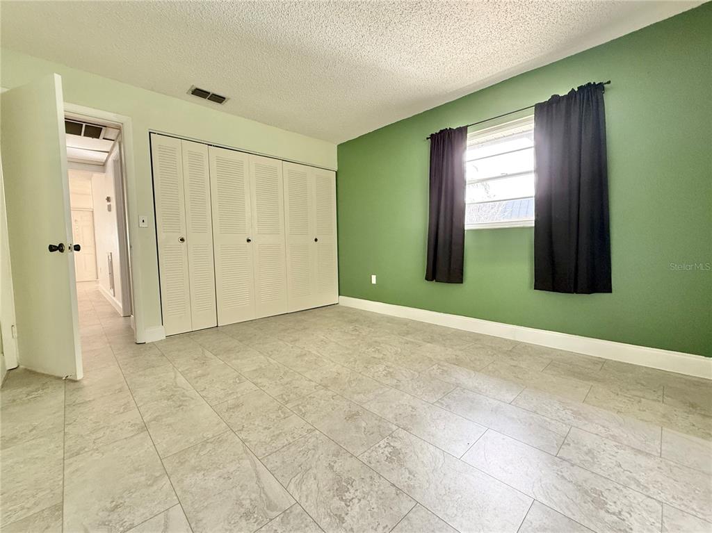 11817 Bayonet Lane New Port Richey, FL 34654 - Photo 9 of 32 a view of an empty room with closet and a window