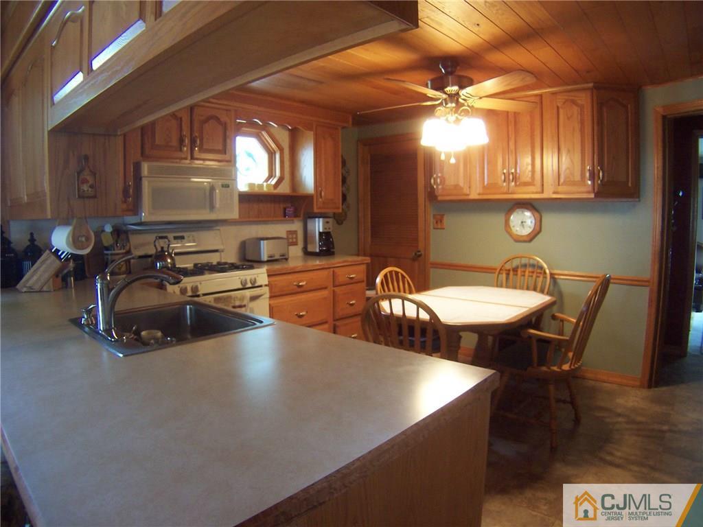 46 West Cliff Road Colonia, NJ 07067 - Photo 3 of 25 a view of a dining room with furniture and a chandelier fan