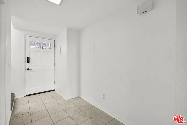 a living room with furniture and stairs