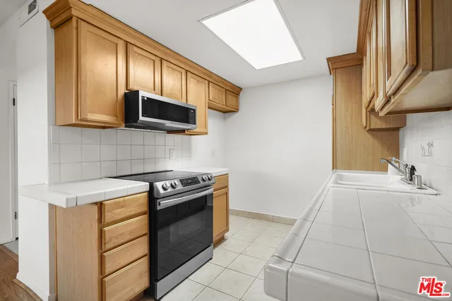 a kitchen with a stove and a microwave