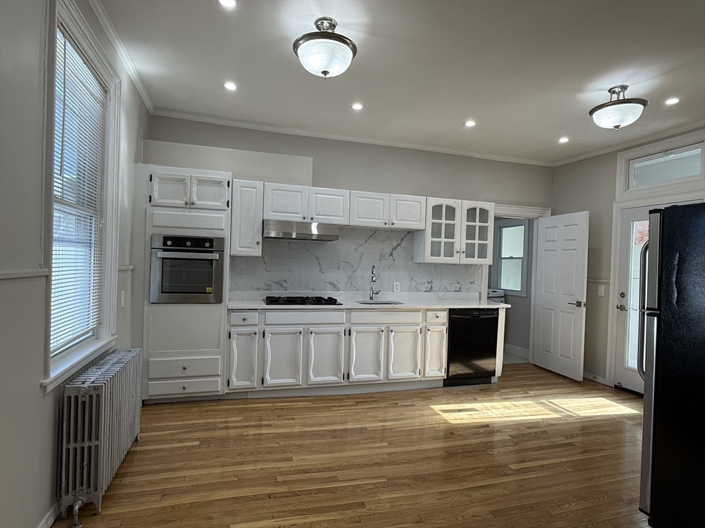 a kitchen with stainless steel appliances granite countertop a stove and a refrigerator