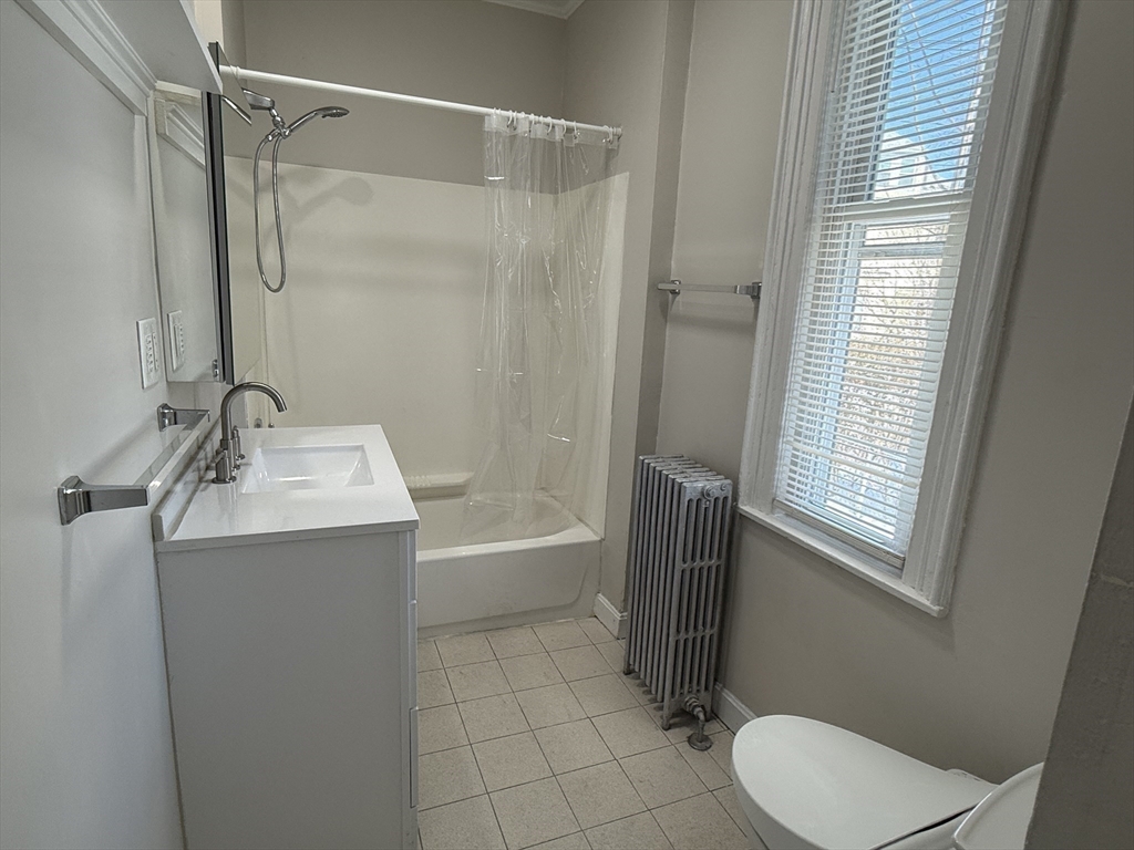 6 Channing Street, Unit 1 Newton, MA 02458 - Photo 12 of 16 a bathroom with a sink a toilet and shower