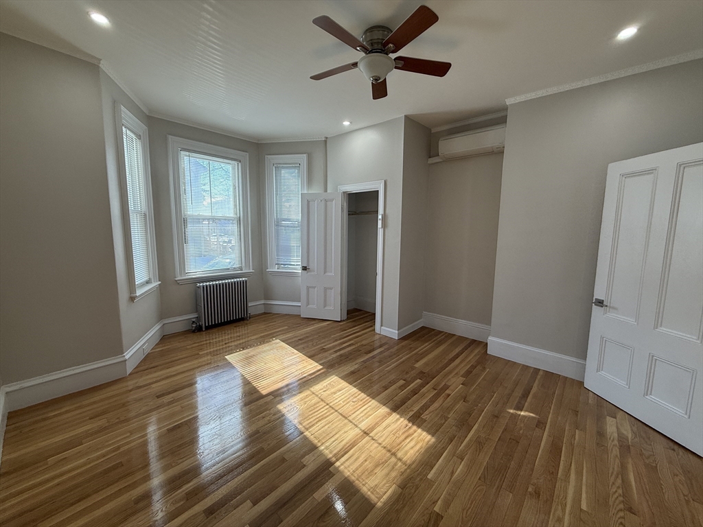 6 Channing Street, Unit 1 Newton, MA 02458 - Photo 14 of 16 a view of empty room with wooden floor and fan