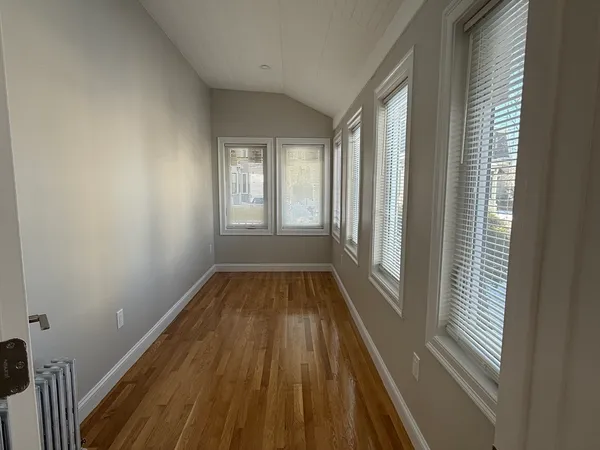 a view of a room with wooden floor and staircase