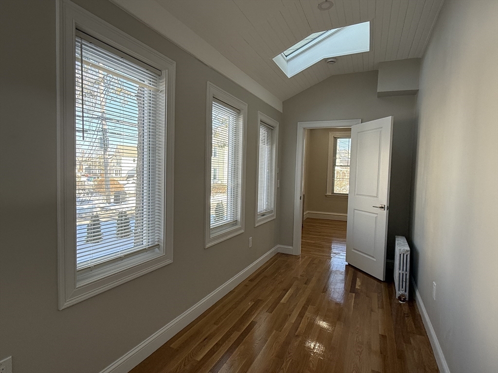 6 Channing Street, Unit 1 Newton, MA 02458 - Photo 7 of 16 a view of a room with wooden floor and a window
