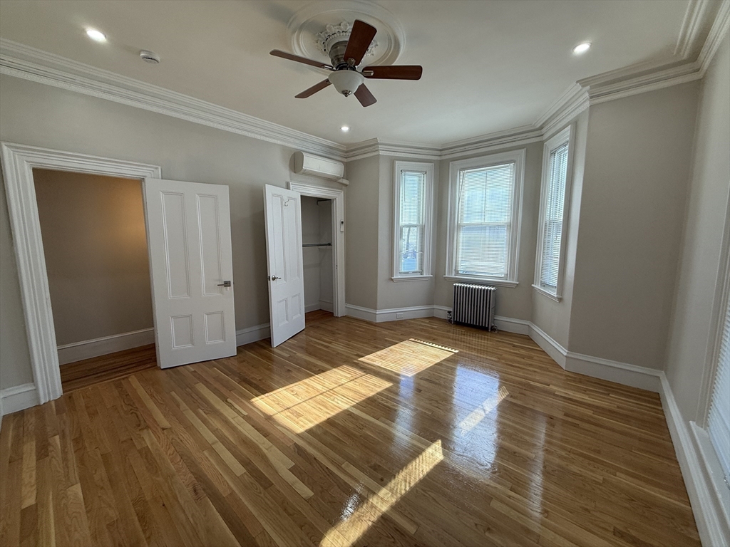 6 Channing Street, Unit 1 Newton, MA 02458 - Photo 9 of 16 a bedroom with a bed and a ceiling fan