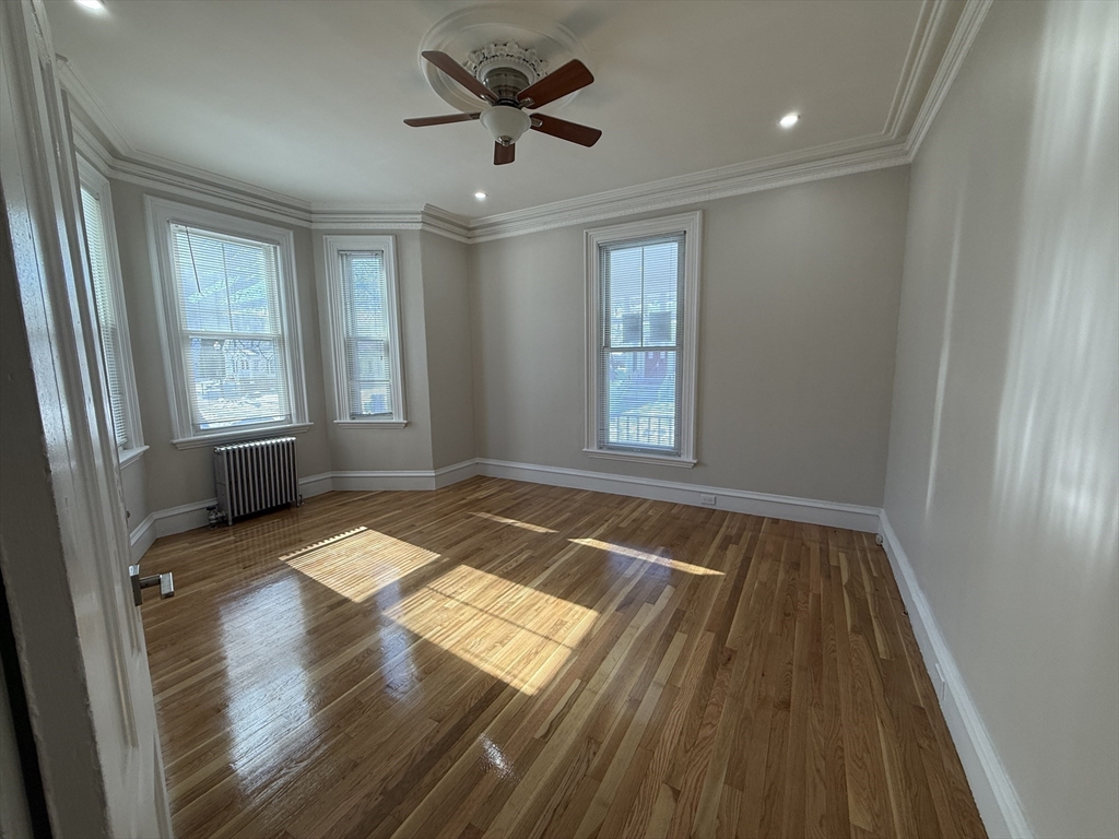 6 Channing Street, Unit 1 Newton, MA 02458 - Photo 10 of 16 wooden floor in an empty room with a window
