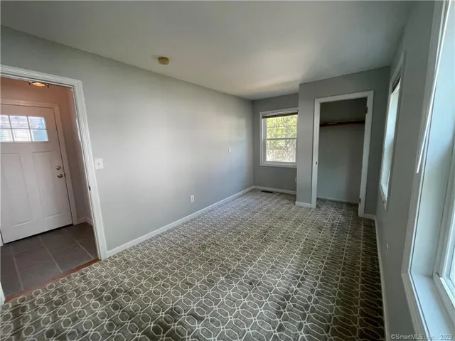 a view of hallway with window and stairs