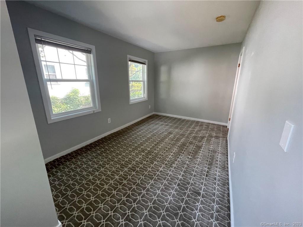 218 Ruane Street Fairfield, CT 06824 - Photo 15 of 26 an empty room with windows