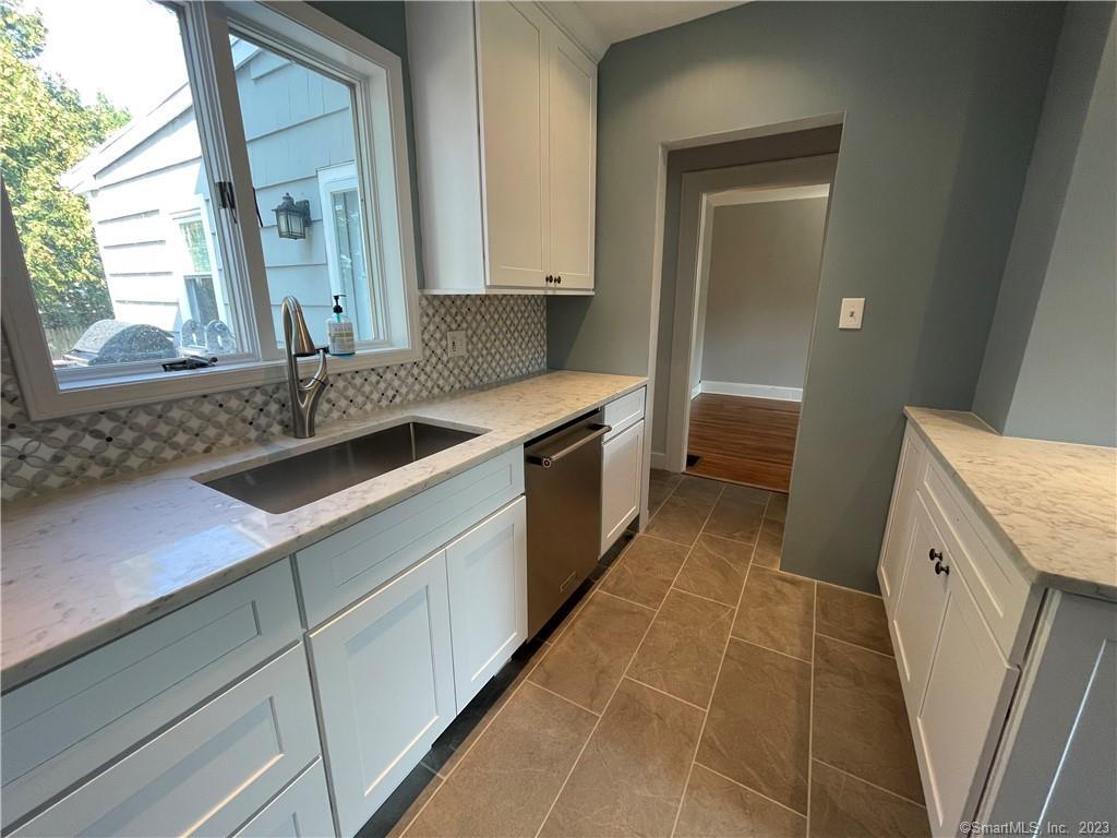 218 Ruane Street Fairfield, CT 06824 - Photo 6 of 26 a kitchen with a sink and a washing machine