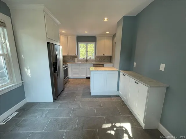 a kitchen with stainless steel appliances a refrigerator and a sink