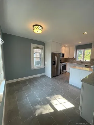 a view of a kitchen with a sink cabinets and a window