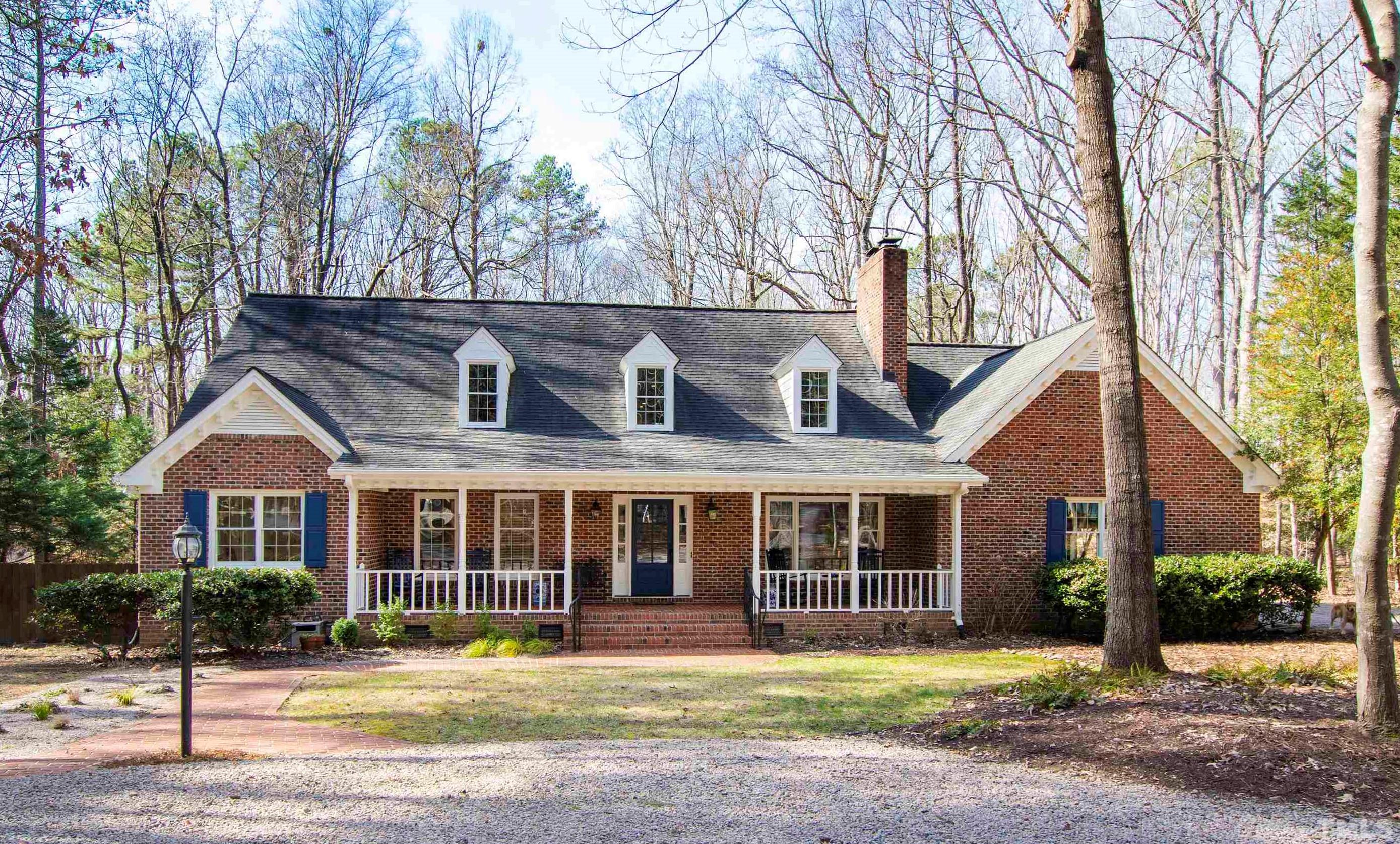 9429 Barton Creek Road Raleigh, NC 27615 - Photo 1 of 78 a front view of a house with a yard and large trees