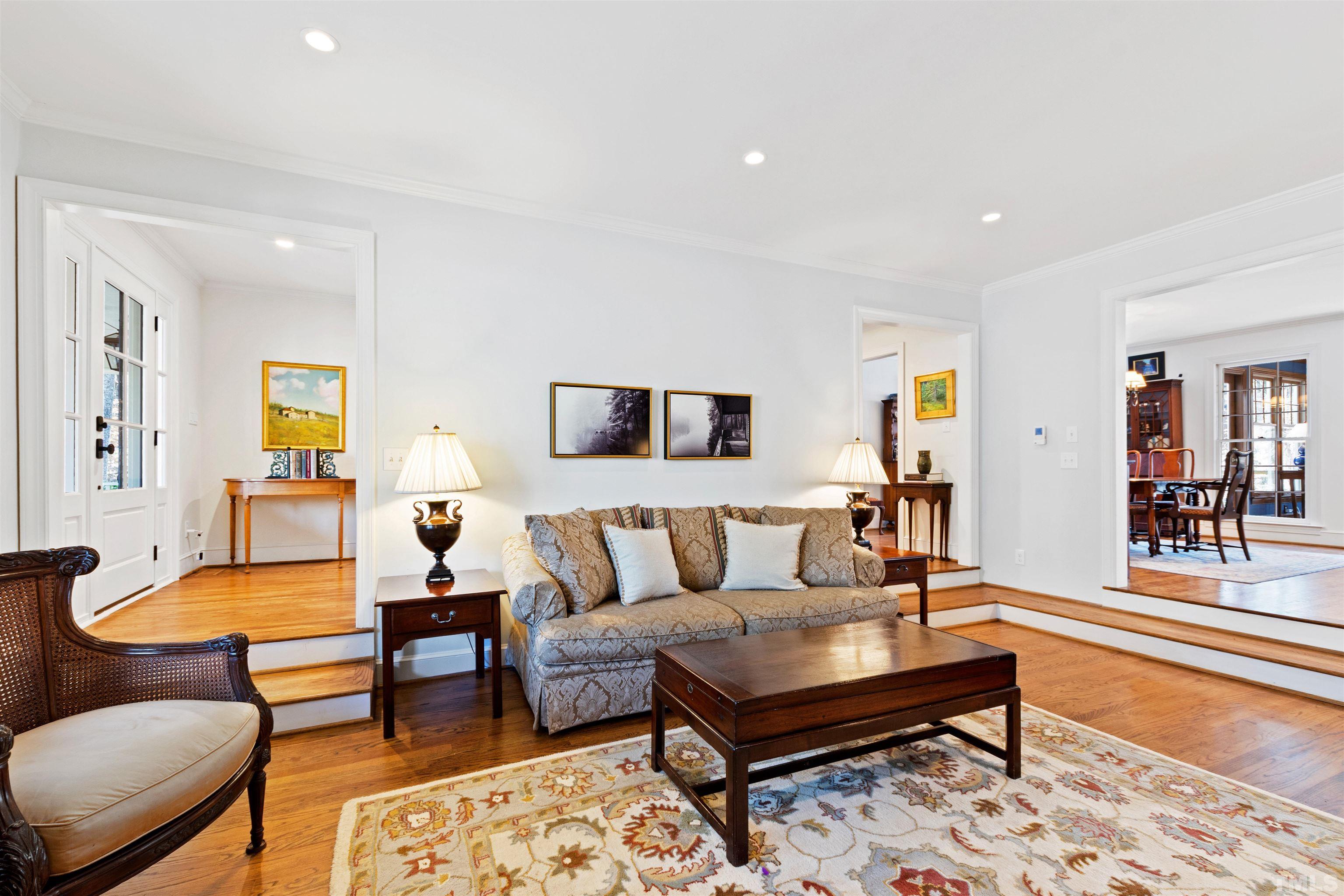 9429 Barton Creek Road Raleigh, NC 27615 - Photo 12 of 78 a living room with furniture a rug and a table