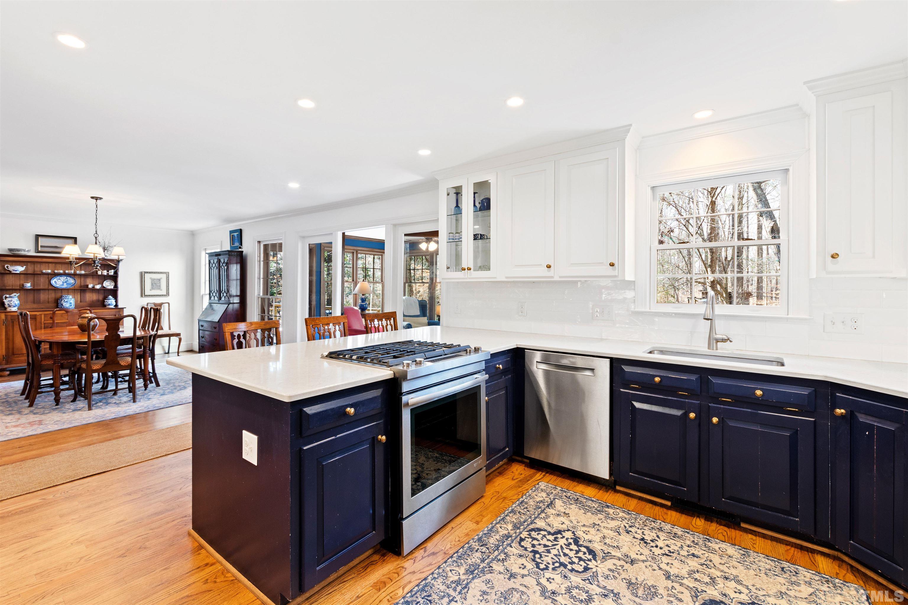 9429 Barton Creek Road Raleigh, NC 27615 - Photo 14 of 78 a large kitchen with stainless steel appliances granite countertop a sink and a refrigerator