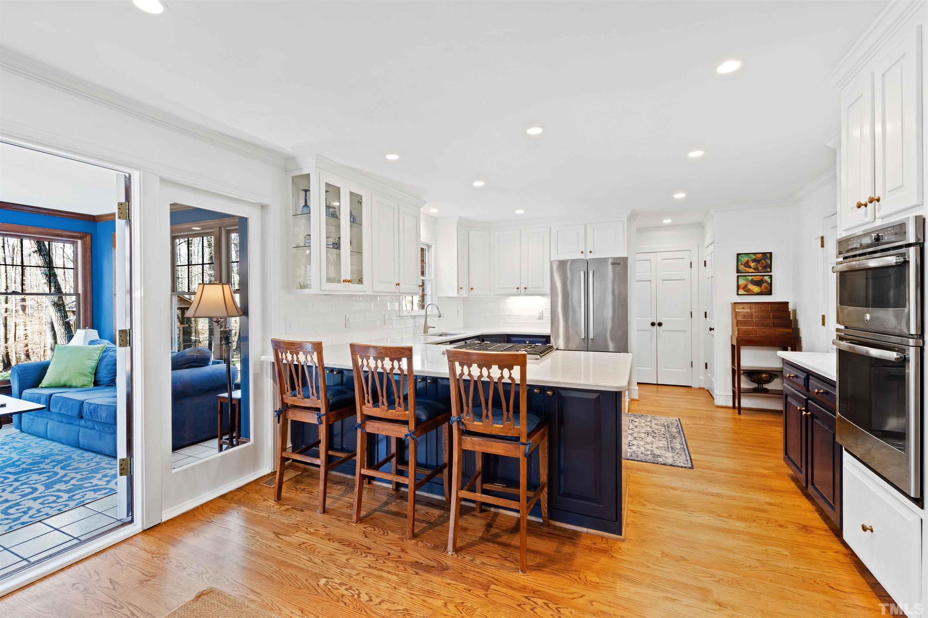 9429 Barton Creek Road Raleigh, NC 27615 - Photo 20 of 78 a dining room with stainless steel appliances kitchen island granite countertop a dining table chairs and granite counter tops