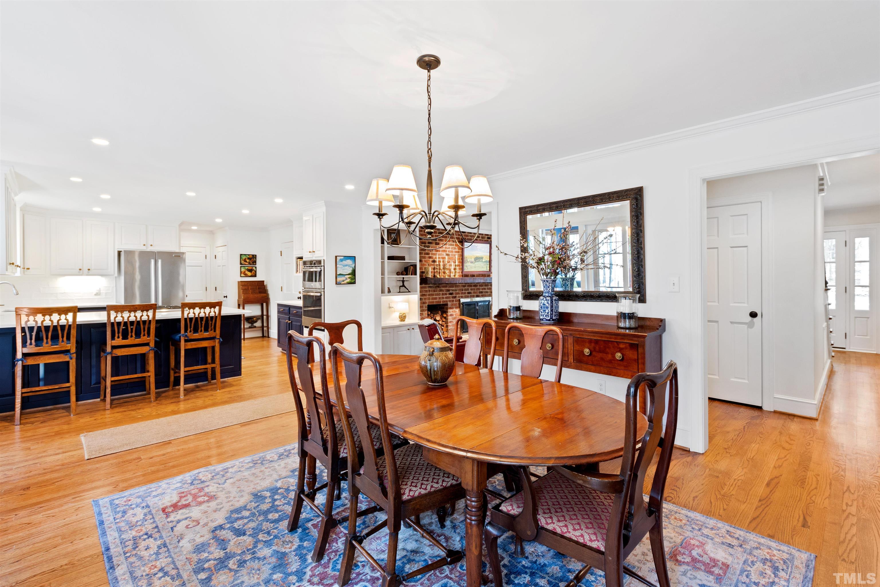 9429 Barton Creek Road Raleigh, NC 27615 - Photo 22 of 78 a dining room with furniture and wooden floor