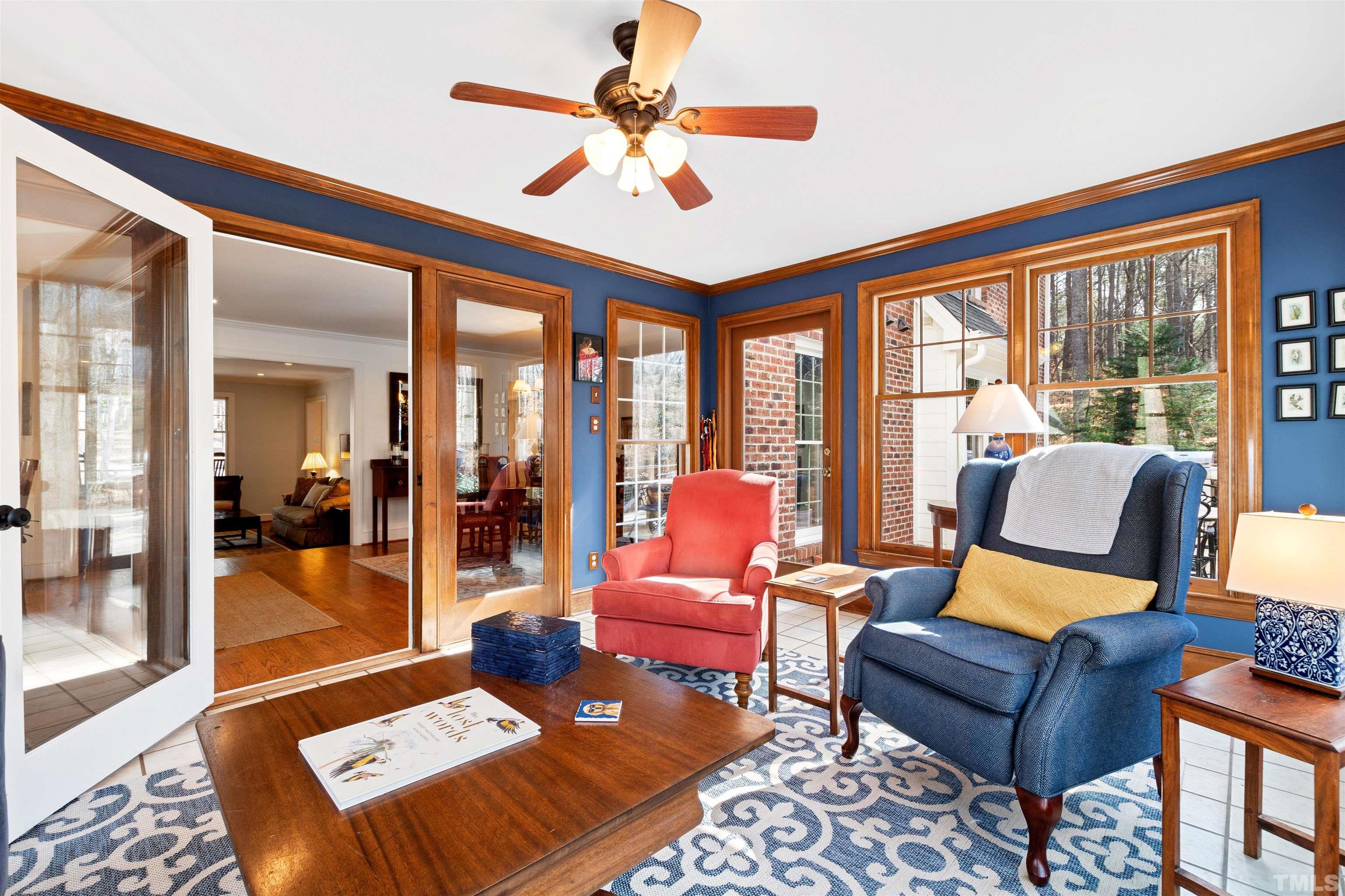 9429 Barton Creek Road Raleigh, NC 27615 - Photo 25 of 78 a living room with furniture a flat screen tv and a floor to ceiling window