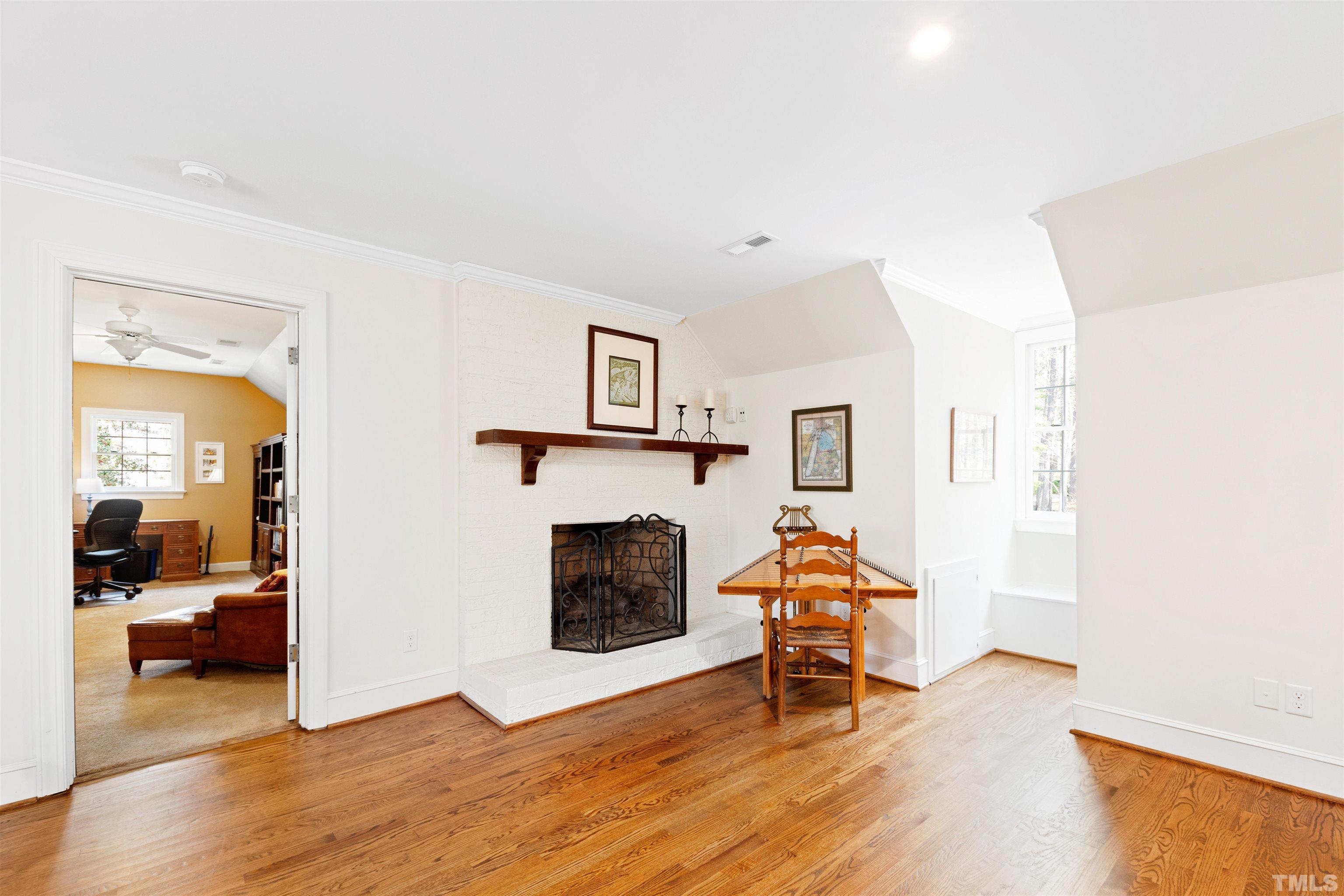 9429 Barton Creek Road Raleigh, NC 27615 - Photo 42 of 78 a living room with furniture and a fireplace