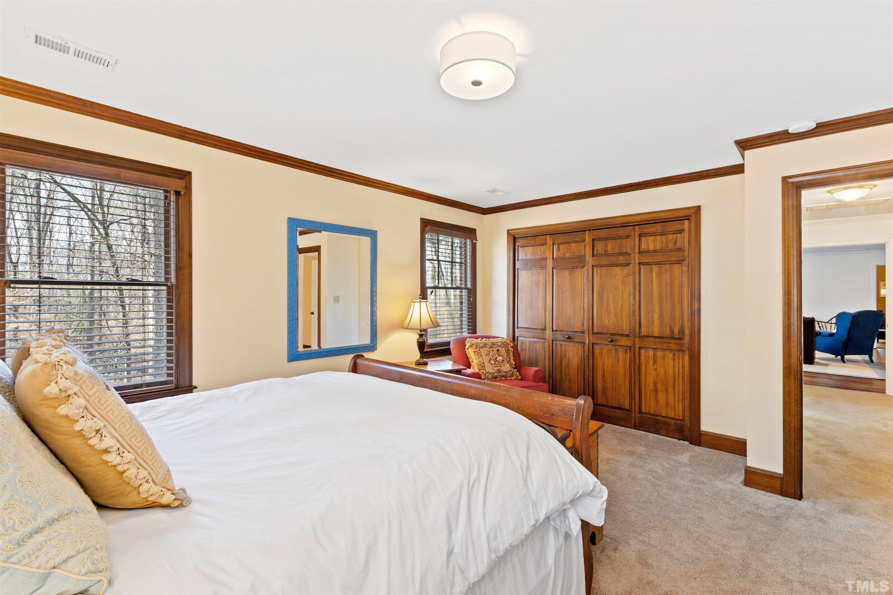 9429 Barton Creek Road Raleigh, NC 27615 - Photo 43 of 78 a bedroom with a bed and glass door