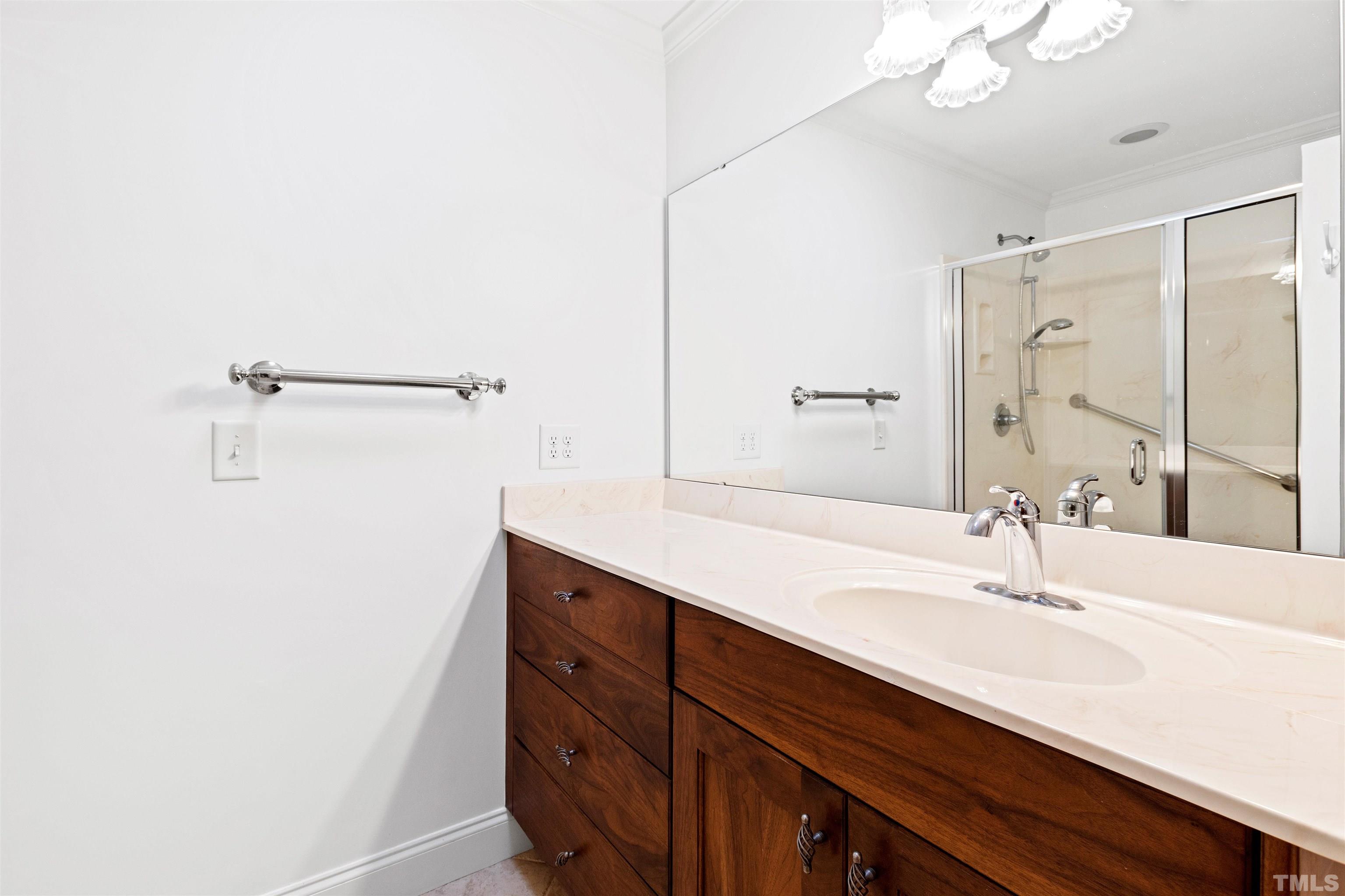 9429 Barton Creek Road Raleigh, NC 27615 - Photo 45 of 78 a bathroom with a sink and a mirror