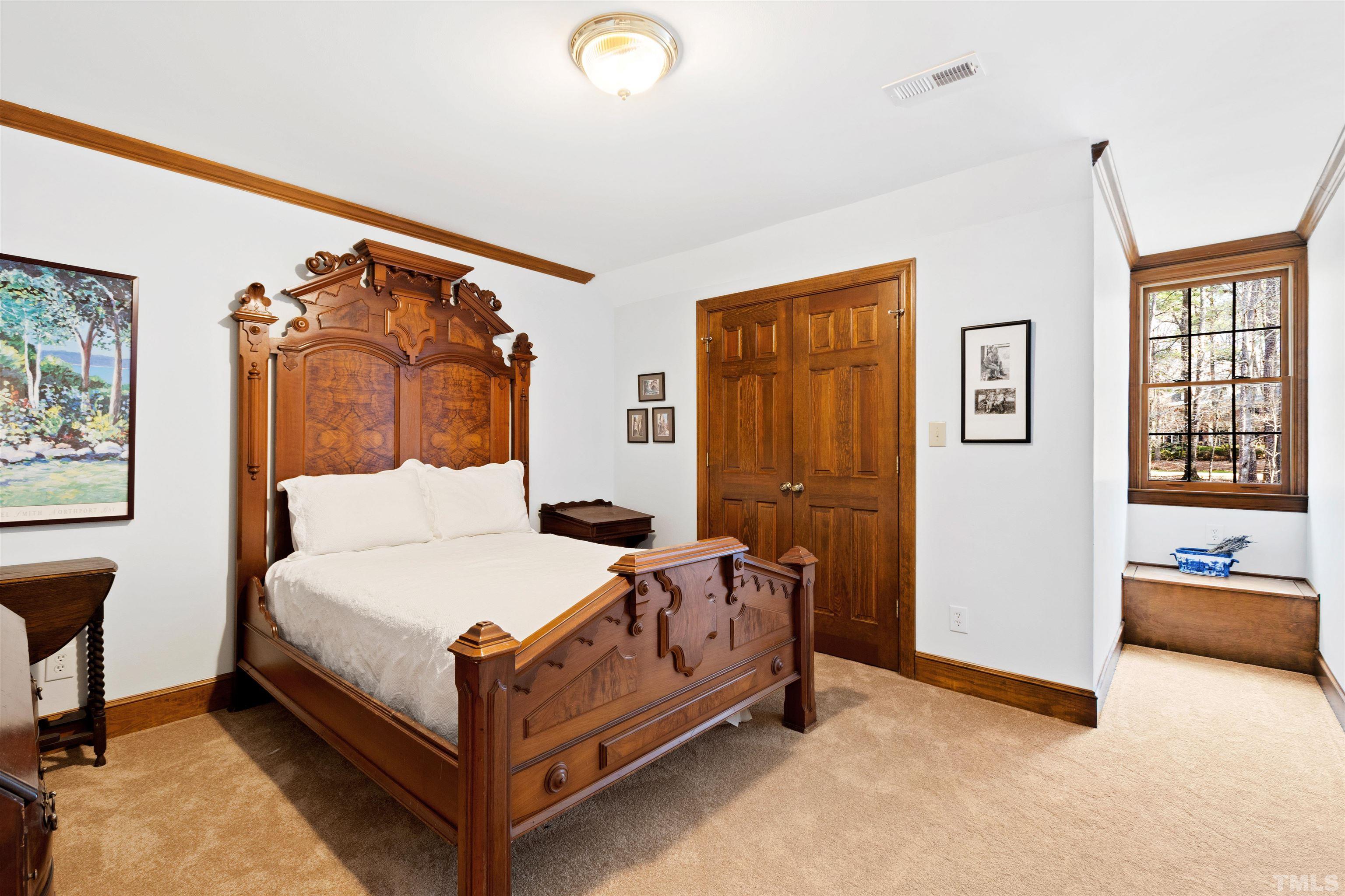 9429 Barton Creek Road Raleigh, NC 27615 - Photo 48 of 78 a bedroom with a bed and wooden floor