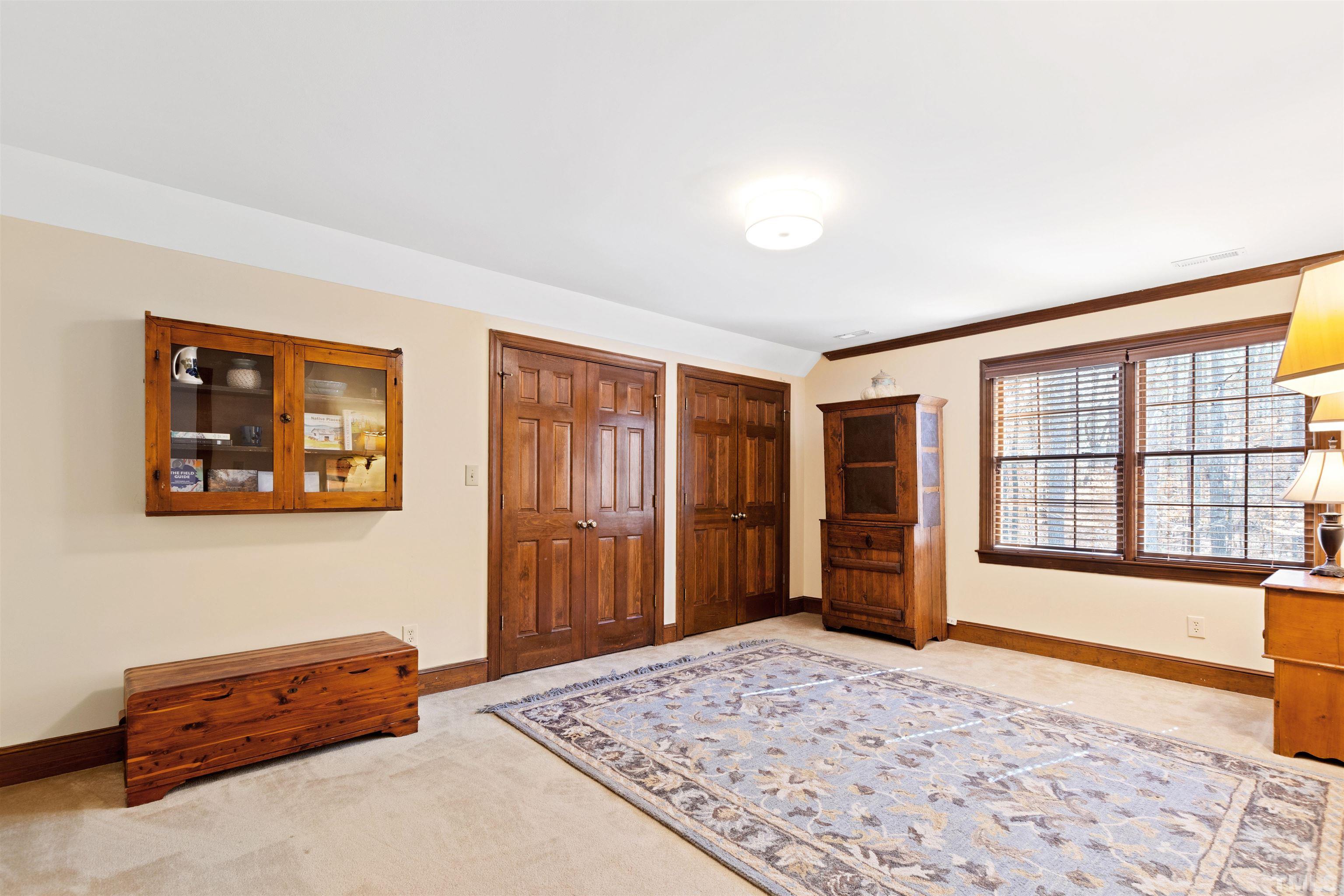 9429 Barton Creek Road Raleigh, NC 27615 - Photo 50 of 78 a bedroom with furniture and large window